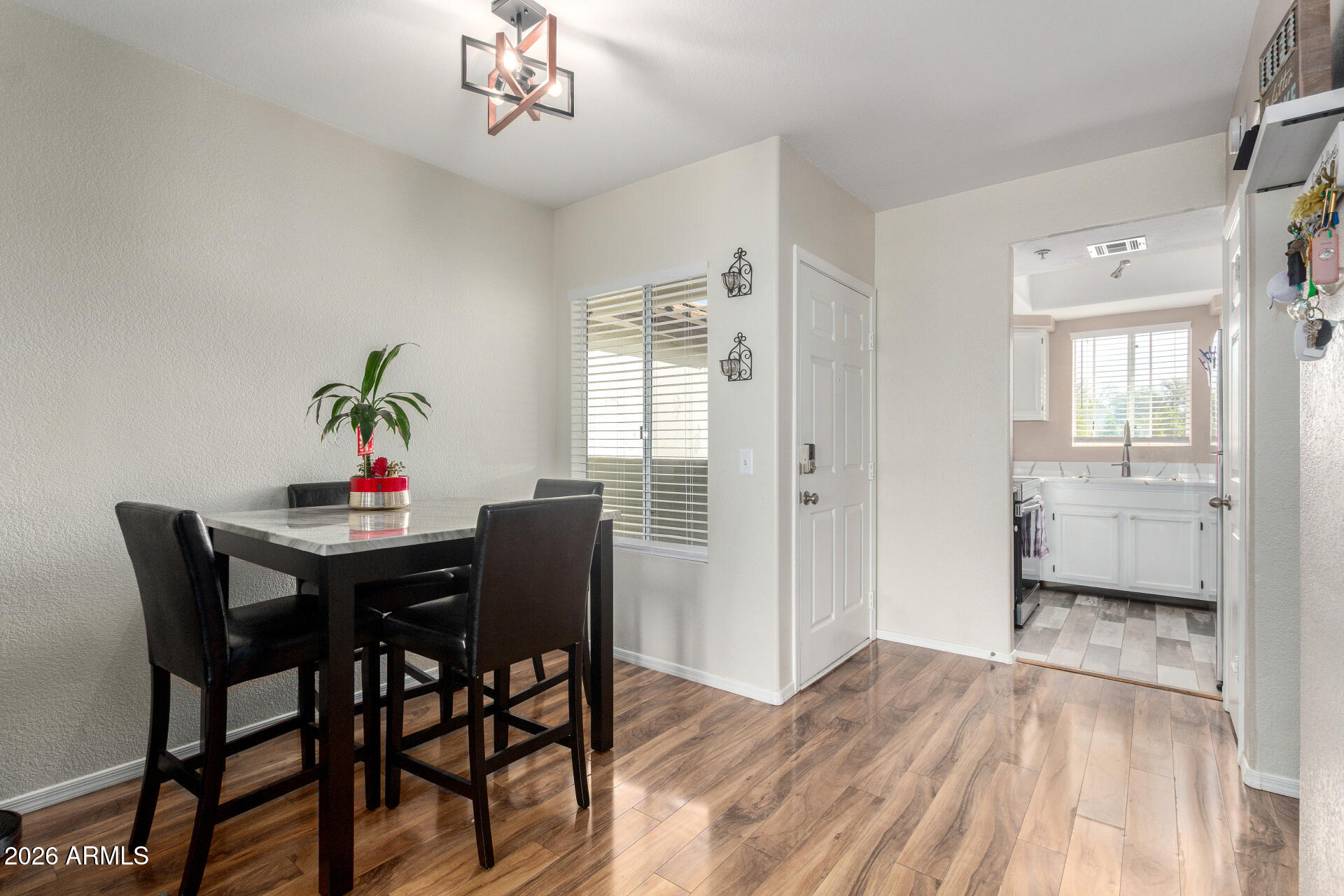 1825 West Ray Road, Unit 2098 Chandler, AZ 85224 - Photo 5 of 30 a view of a dining room with furniture window and wooden floor