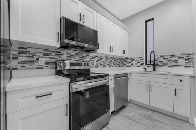 a kitchen with a refrigerator stove and microwave