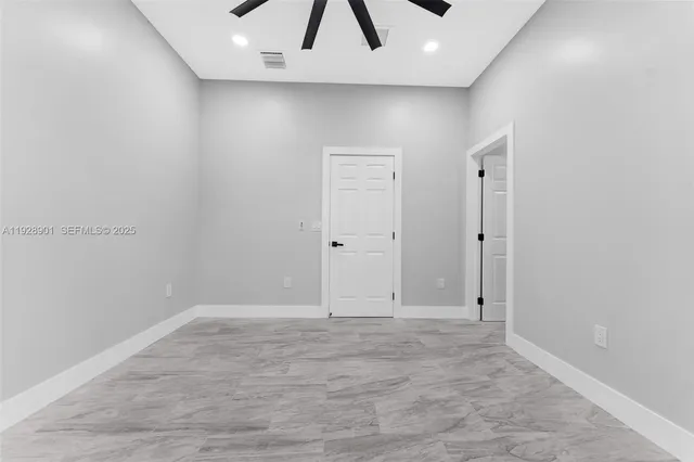 an empty room with a empty space and a ceiling fan