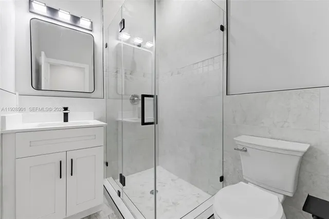 a bathroom with a sink a mirror and shower
