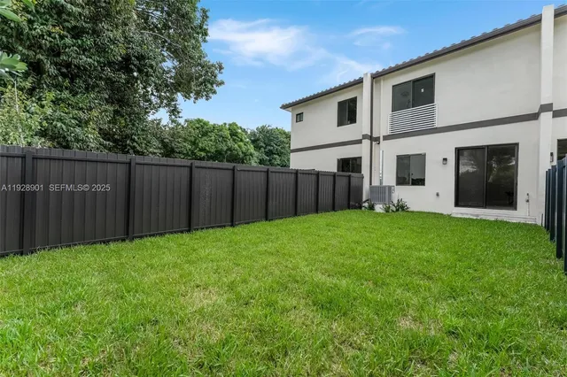 an aerial view of a house with a yard and trees