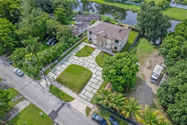 an aerial view of a city with lots of residential buildings lake and mountain view in back