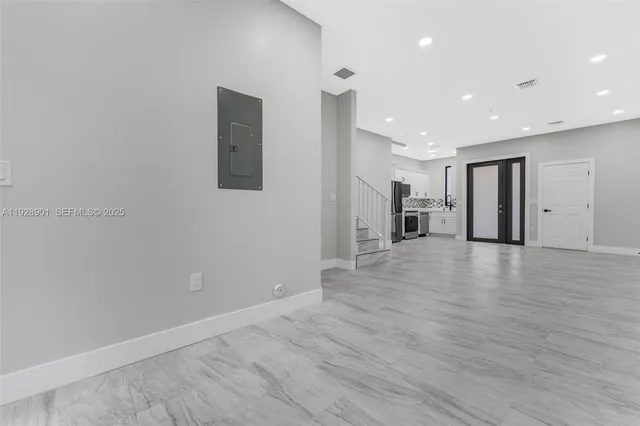 a view of empty room with wooden floor
