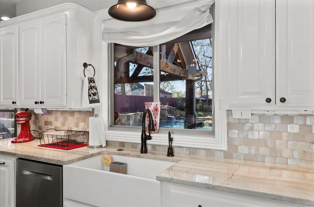 3815 Holly Ridge Drive Longview, TX 75605 - Photo 10 of 40 a kitchen with stainless steel appliances granite countertop a sink and a white cabinets