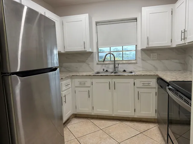 a white toilet sitting next to a shower