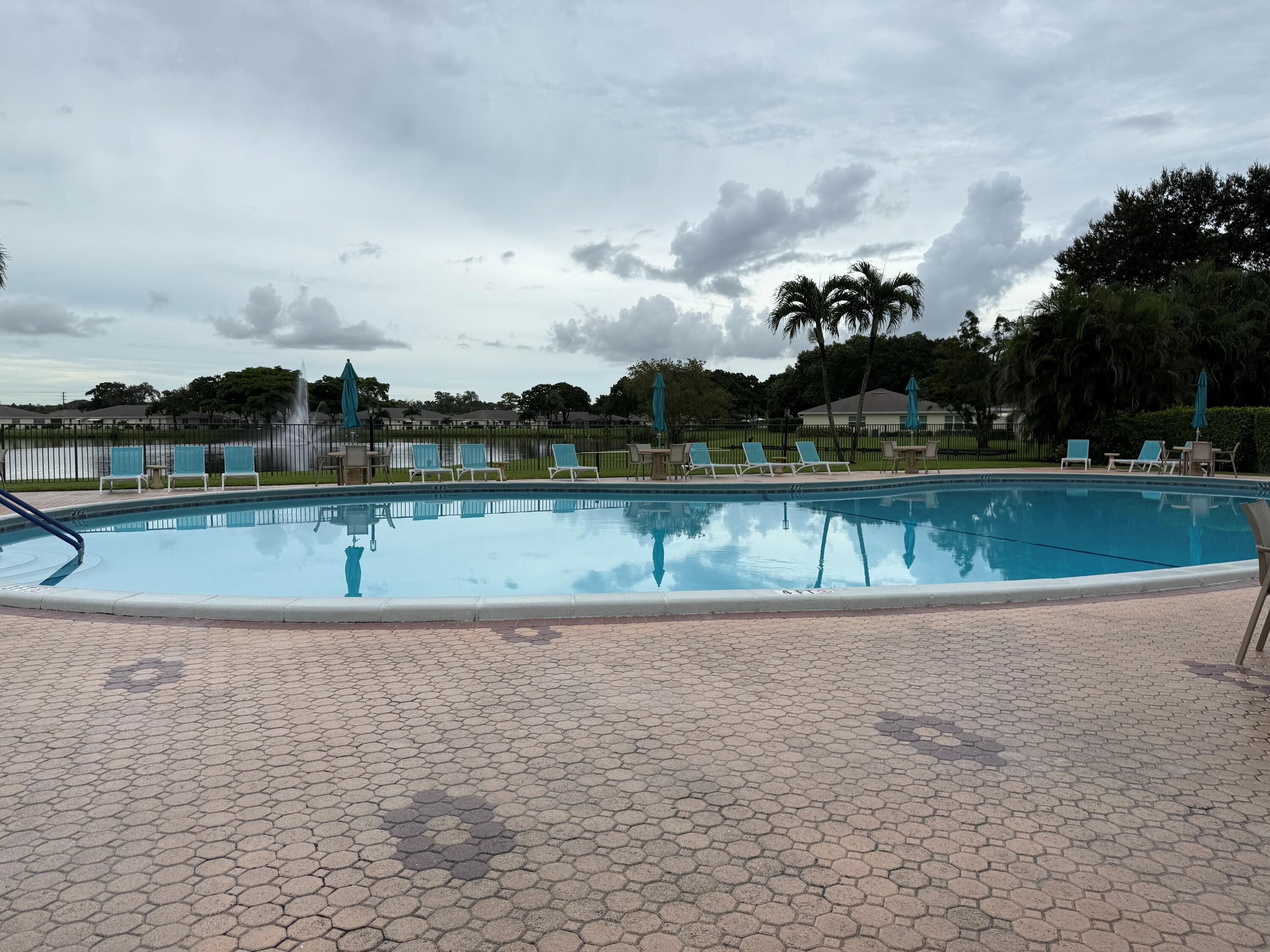 14676 Canalview Drive, Unit A Delray Beach, FL 33484 - Photo 27 of 33 a view of a lake with houses in the back