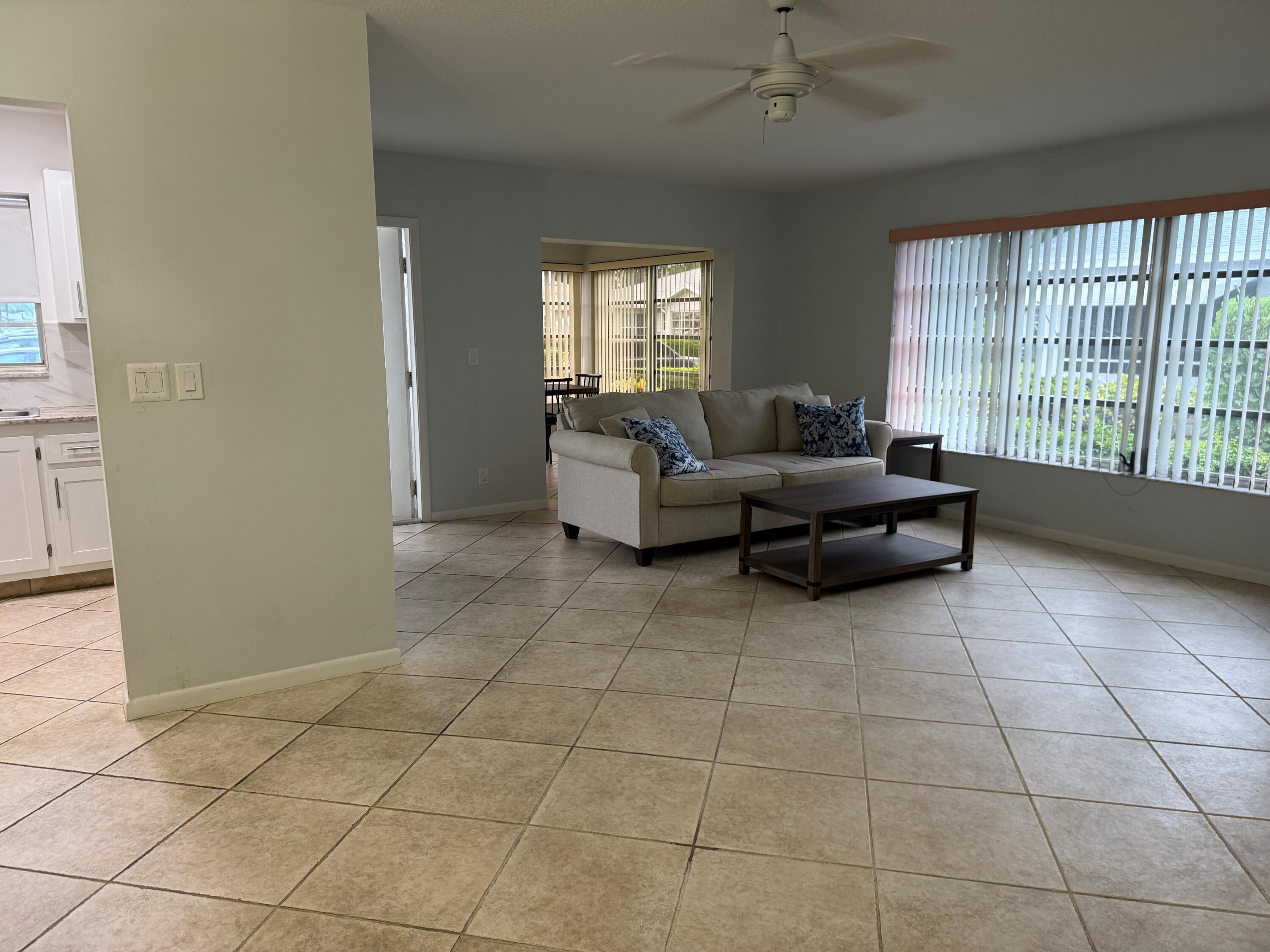 14676 Canalview Drive, Unit A Delray Beach, FL 33484 - Photo 4 of 33 a living room with couches and large windows