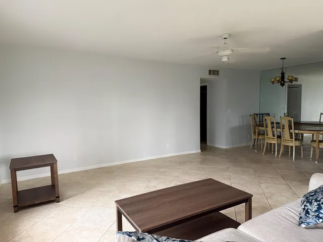 a kitchen with granite countertop white cabinets and a sink