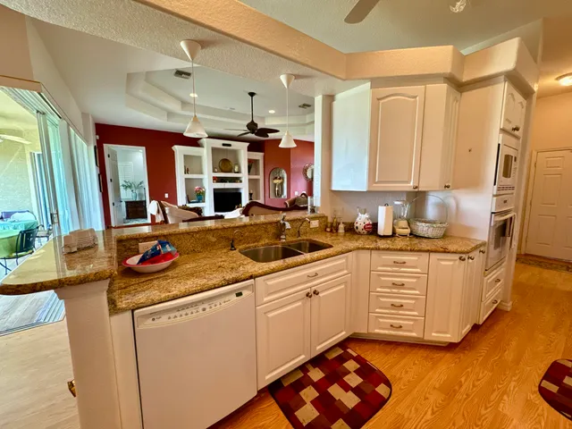 a kitchen with stainless steel appliances granite countertop a sink stove and cabinets