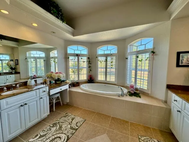 a large spacious bathroom with a large tub and sink