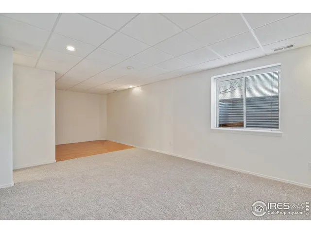 a living room with furniture a flat screen tv and a pool table