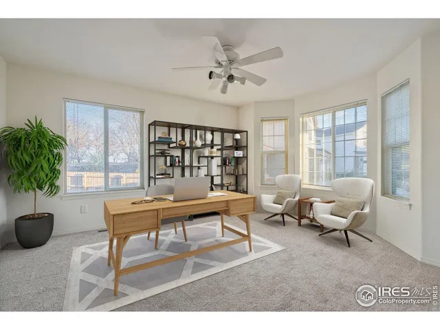 a living room with furniture a chandelier and a window