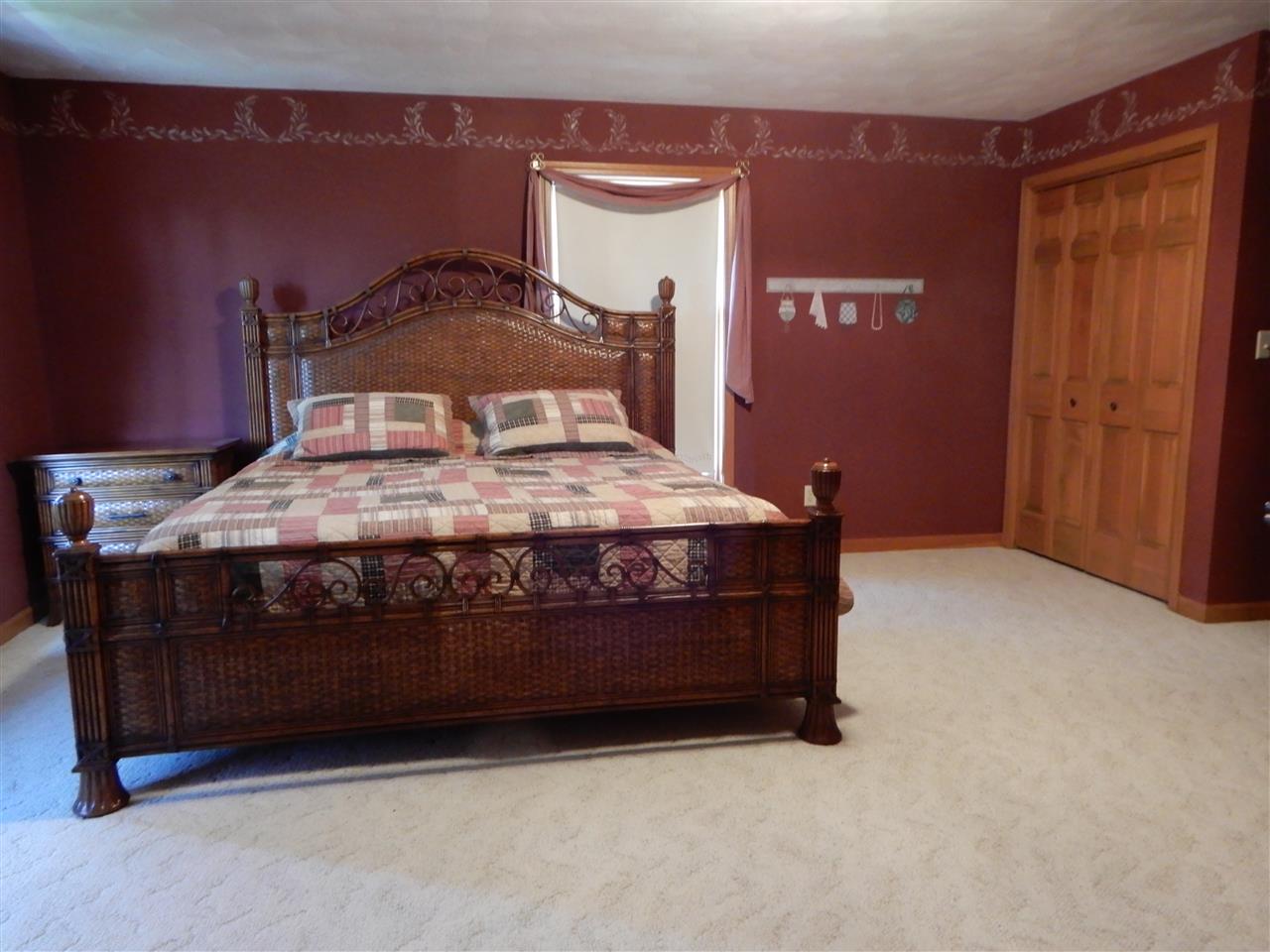 12145 Caledonia Road Belvidere, IL 61008 - Photo 14 of 25 a room with a bed and a dresser