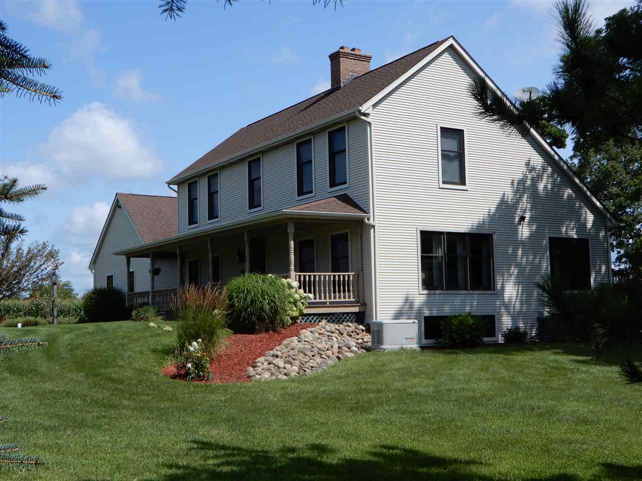 12145 Caledonia Road Belvidere, IL 61008 - Photo 22 of 25 a front view of a house with a yard and garage