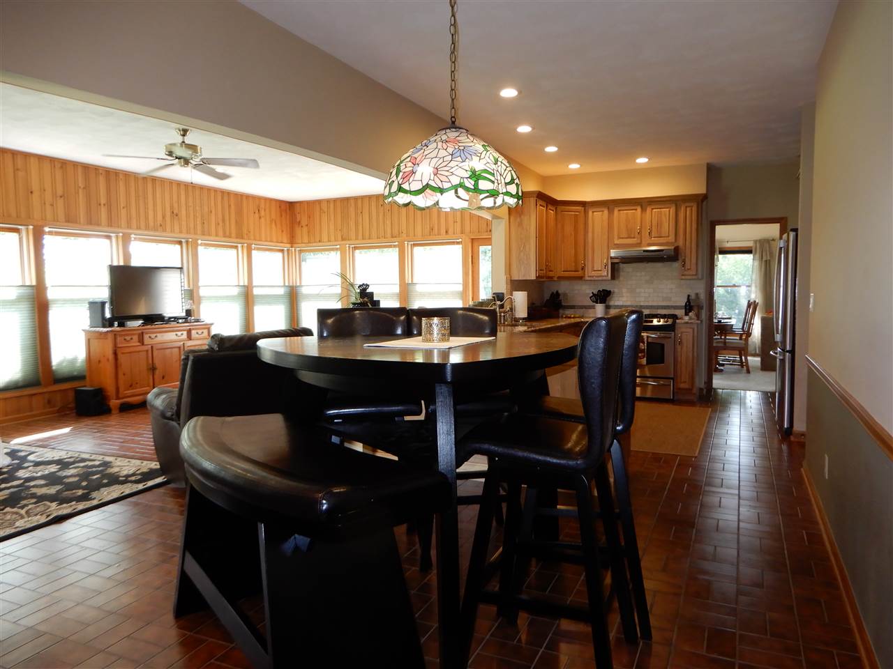 12145 Caledonia Road Belvidere, IL 61008 - Photo 5 of 25 a large kitchen with a table and chairs