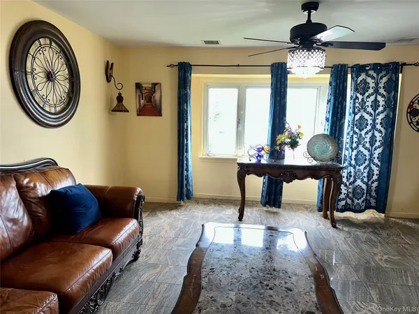 a living room with furniture a window and a chandelier