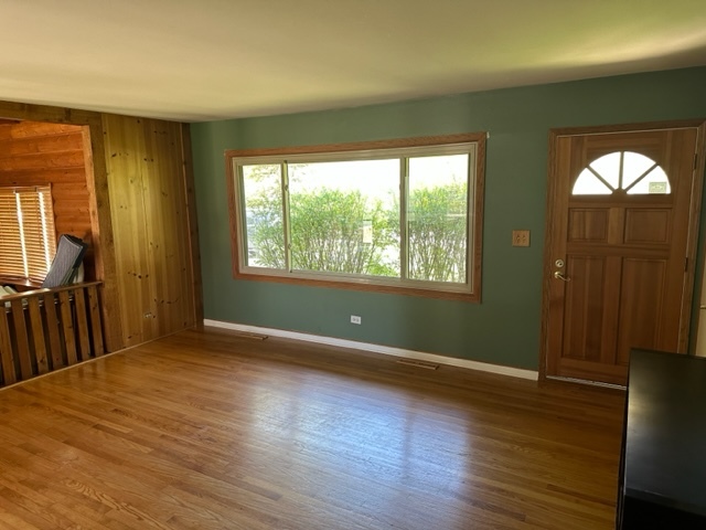 2217 West Palatine Road Inverness, IL 60067 - Photo 4 of 17 a view of empty room with wooden floor and fan