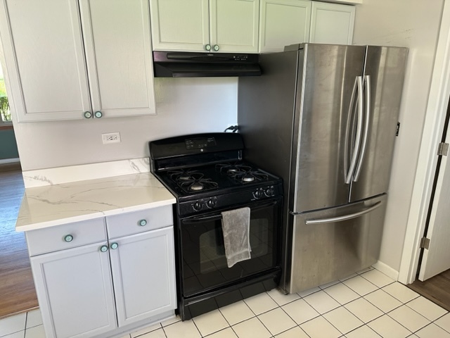 2217 West Palatine Road Inverness, IL 60067 - Photo 6 of 17 a kitchen with stainless steel appliances white cabinets and a refrigerator