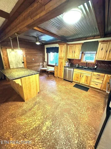 a swimming pool with a lawn chairs and large tree