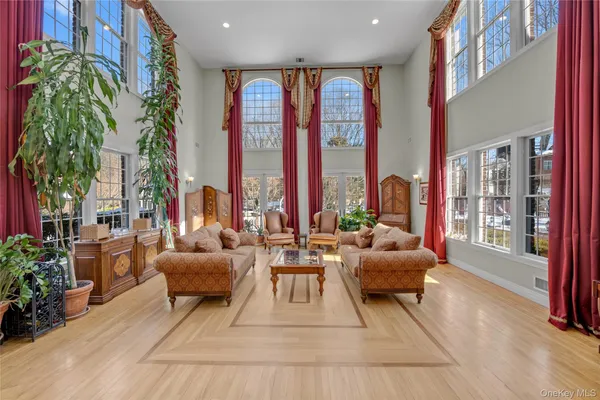 a living room with furniture and large windows
