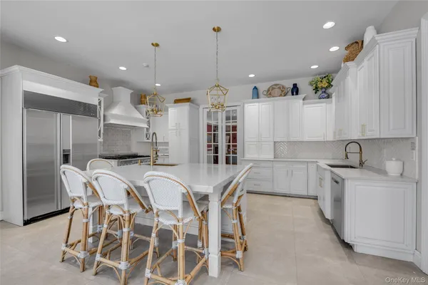 a large kitchen with a table and chairs