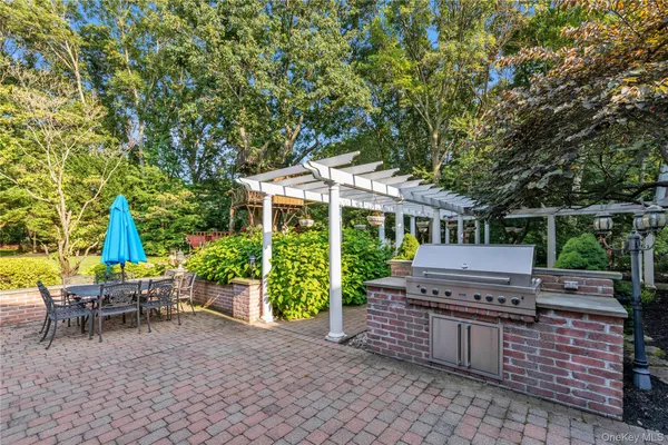 a view of a chairs and table in backyard