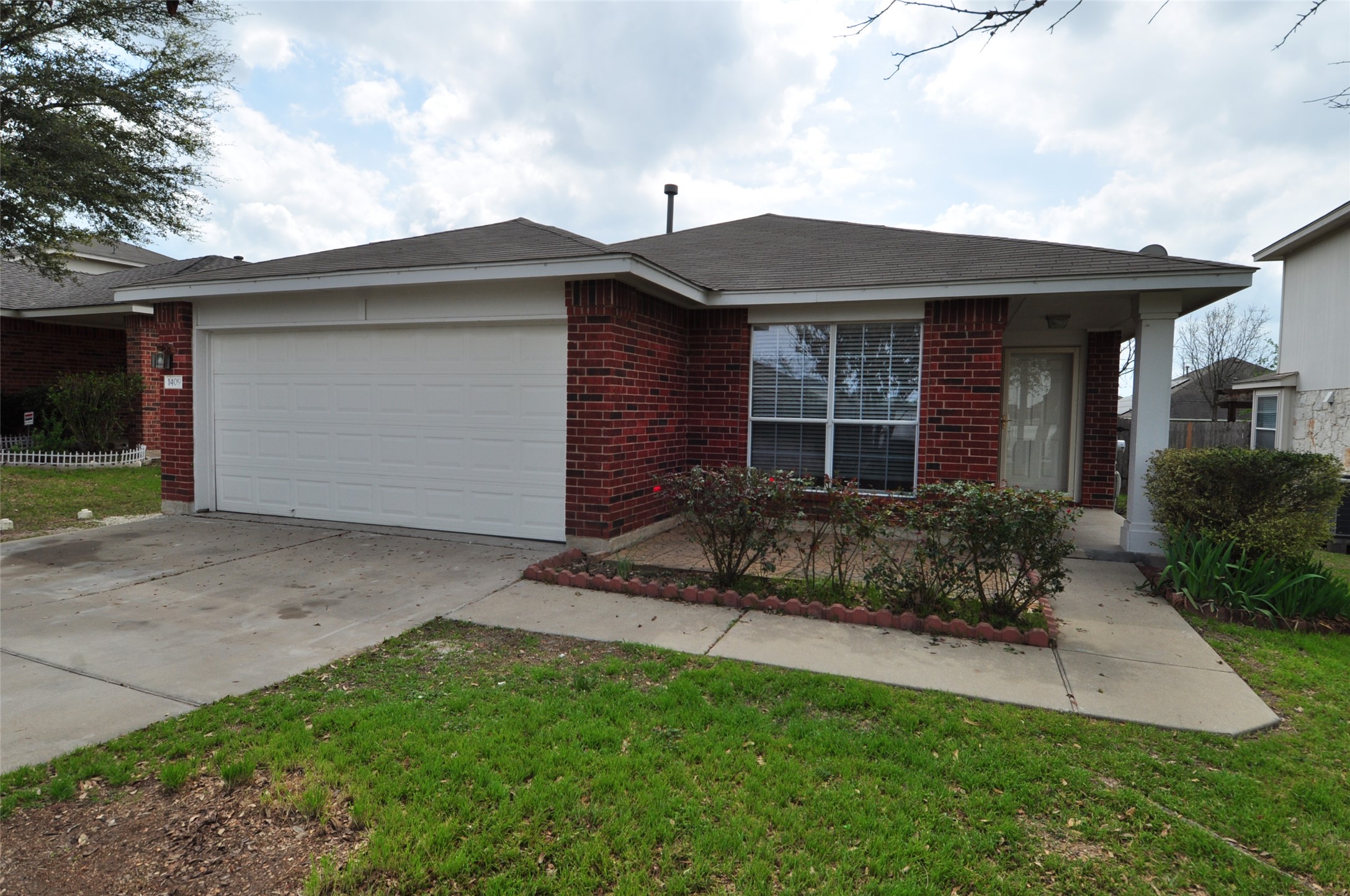 1409 Tea Leaf Drive Pflugerville, TX 78660 - Photo 3 of 18 A classic brick facade welcomes you home, complete with an attached garage and neatly landscaped front yard.