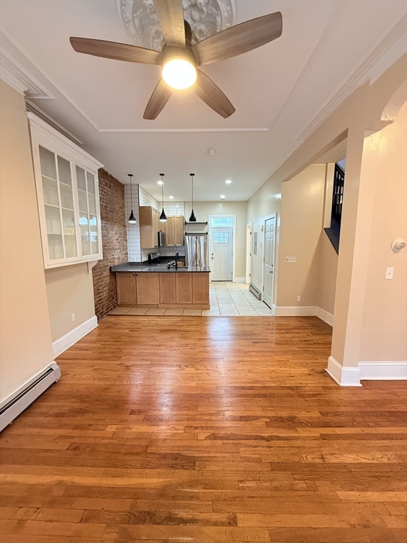 57 Coleman Street, Unit 2 Boston, MA 02125 - Photo 11 of 24 a view of kitchen and dining room with wooden floor
