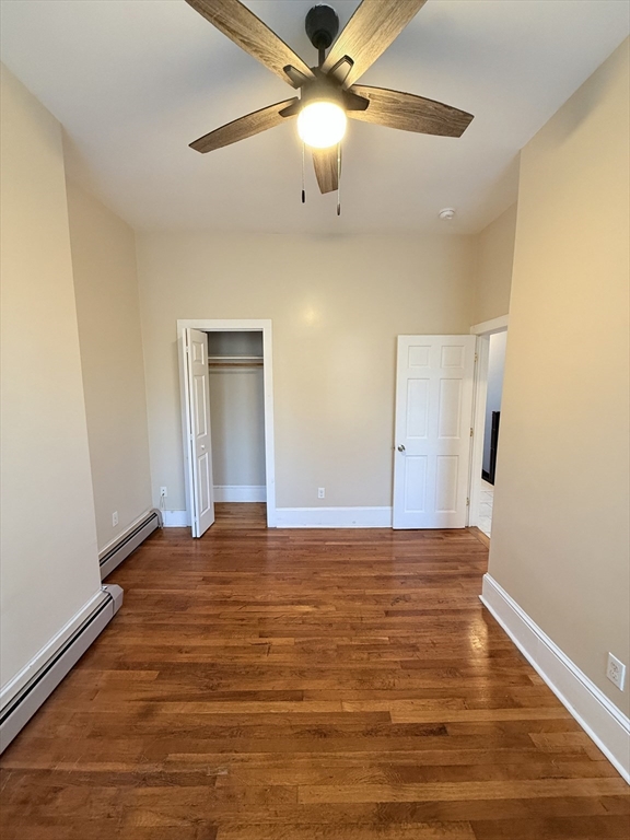 57 Coleman Street, Unit 2 Boston, MA 02125 - Photo 17 of 24 a view of an empty room with window and wooden floor