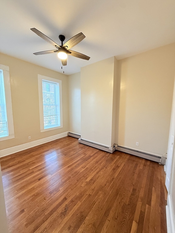 57 Coleman Street, Unit 2 Boston, MA 02125 - Photo 18 of 24 a view of an empty room with wooden floor and a window