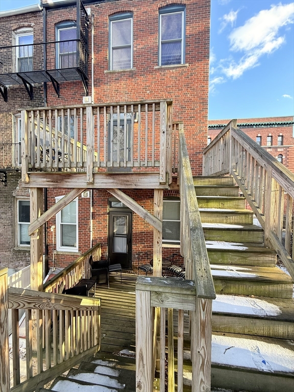 57 Coleman Street, Unit 2 Boston, MA 02125 - Photo 23 of 24 a view of a building with a small yard