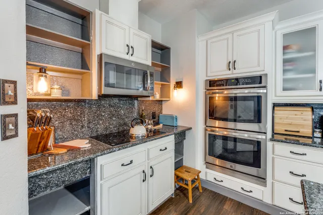 a view of entryway with kitchen island wooden floor and window