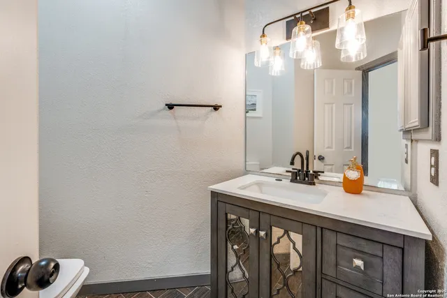 a bedroom with a bed and a view of kitchen