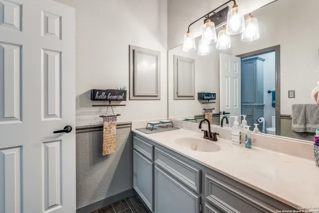 a bathroom with a sink and a mirror