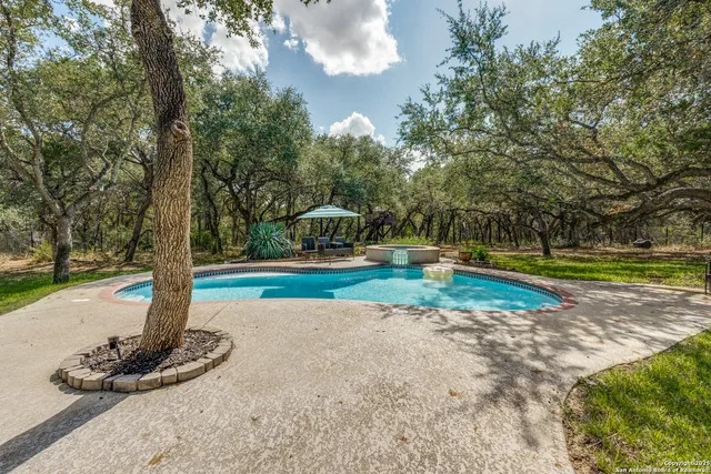 a view of a swimming pool with a yard