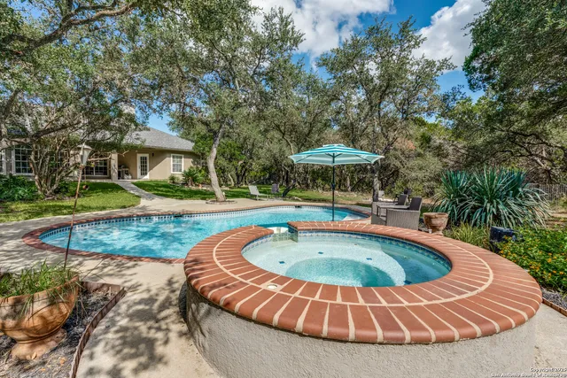 a view of a swimming pool with a yard