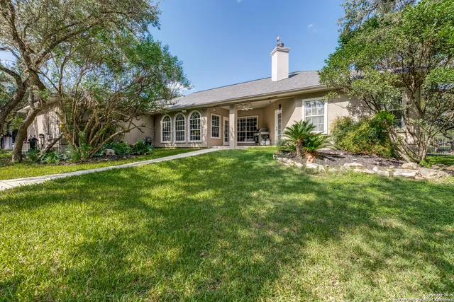 a view of a chairs and table in backyard