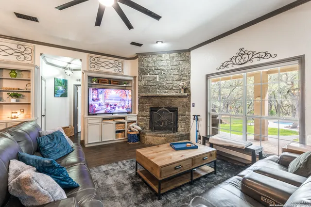 a living room with furniture ceiling fan and a rug
