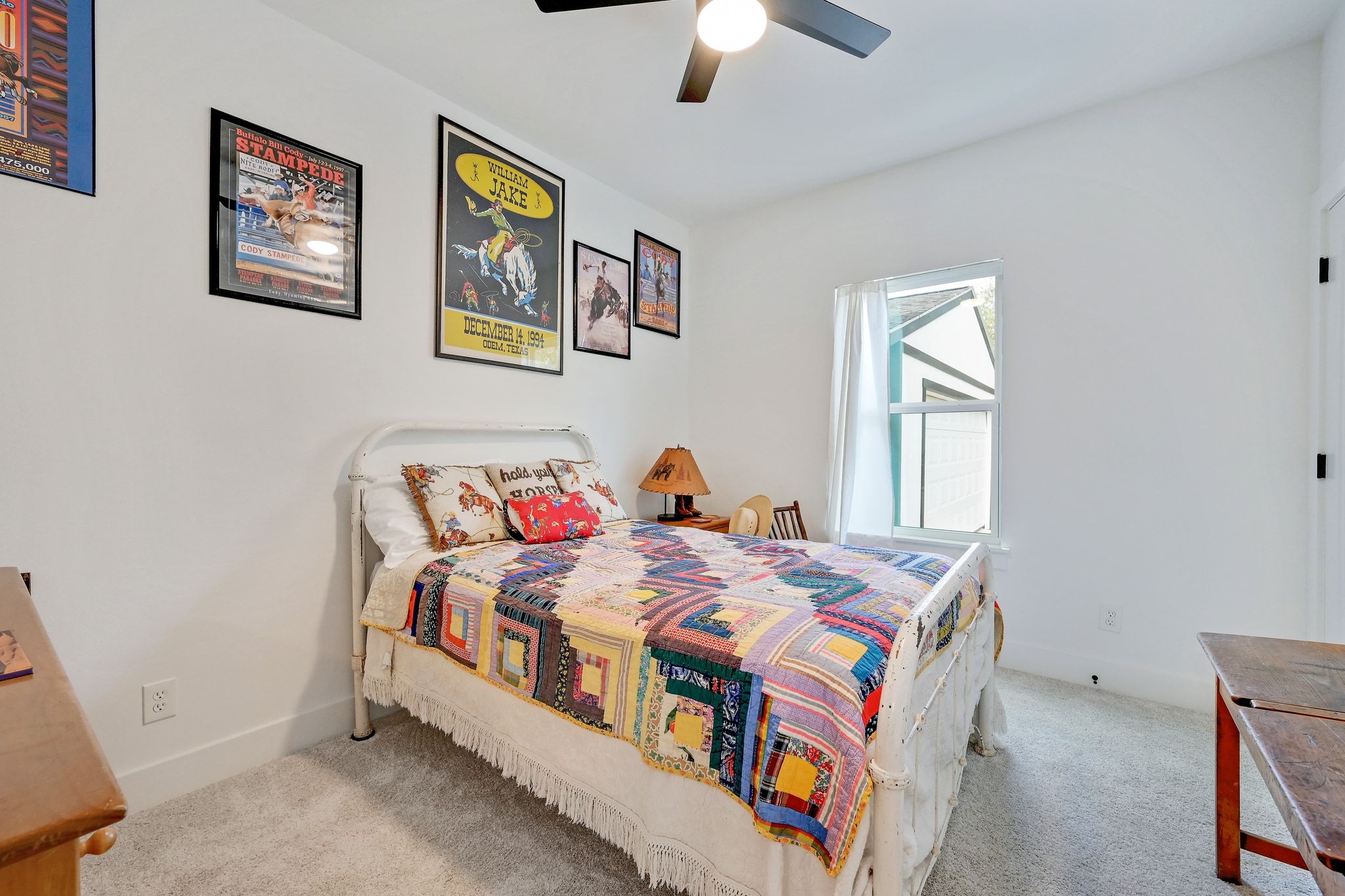 200 Rust Ranch Road Blanco, TX 78606 - Photo 15 of 26 a bedroom with a bed and a chandelier