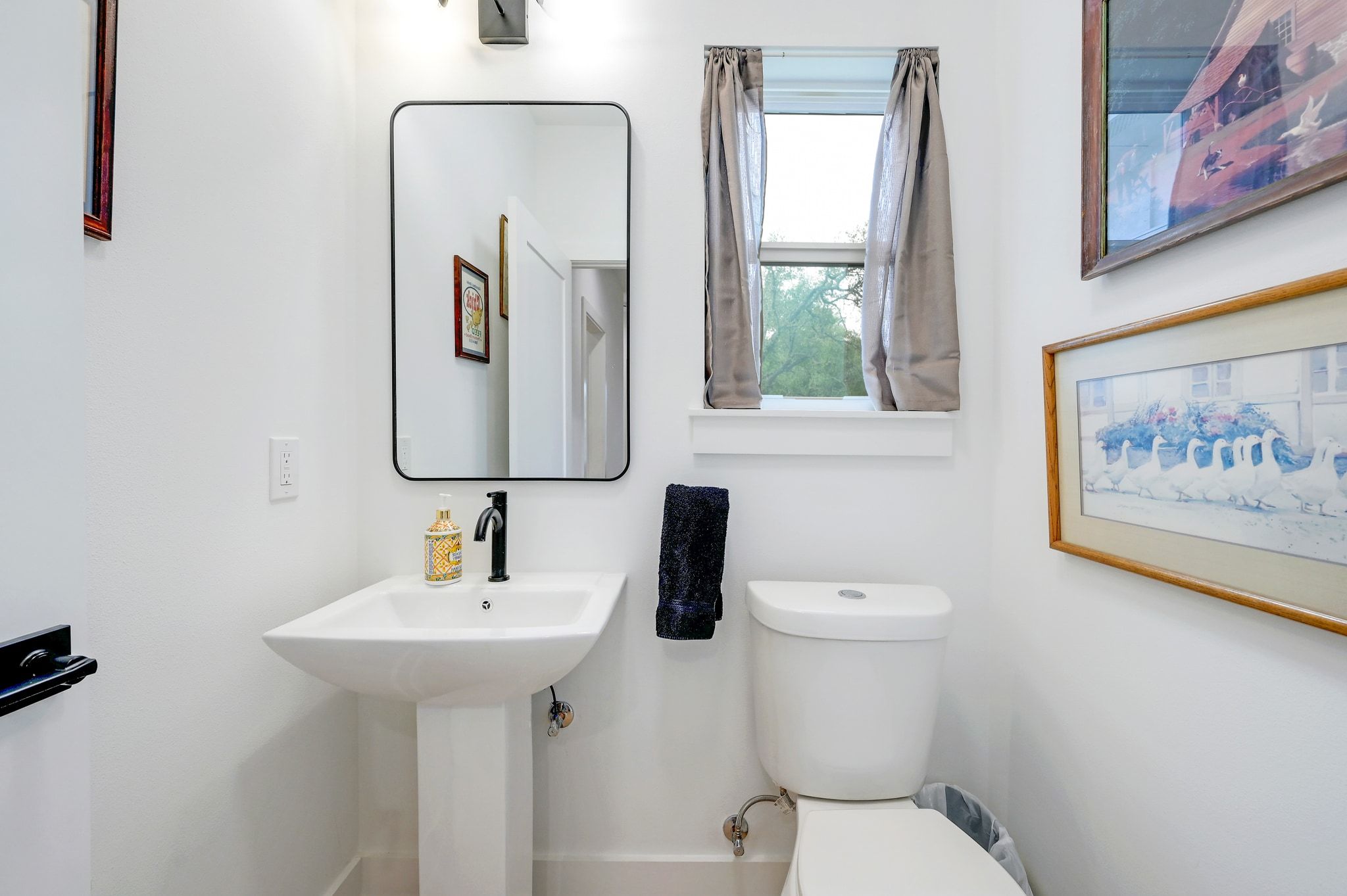 200 Rust Ranch Road Blanco, TX 78606 - Photo 19 of 26 a bathroom with a toilet sink and mirror