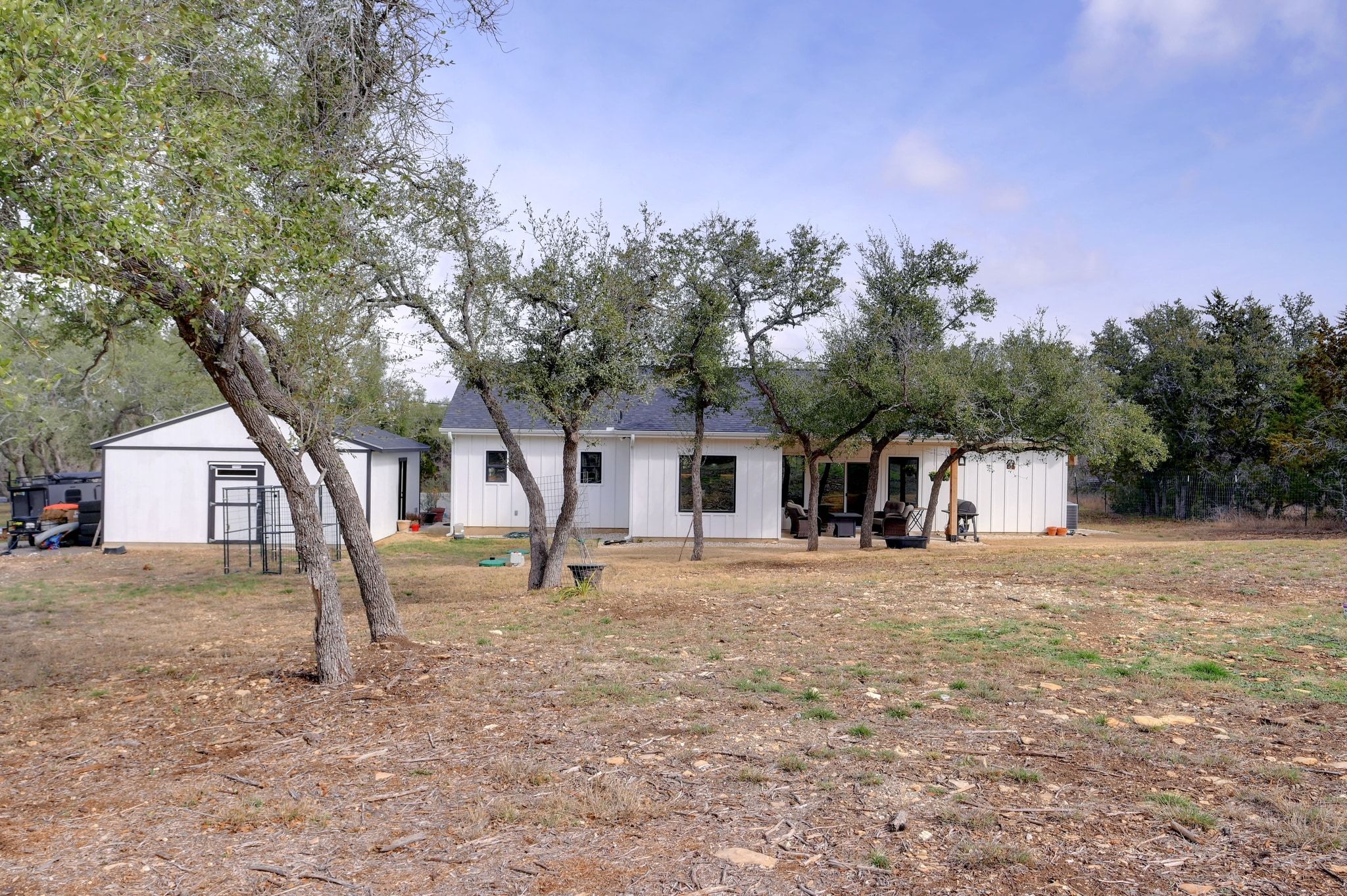 200 Rust Ranch Road Blanco, TX 78606 - Photo 21 of 26 a house with trees in the background