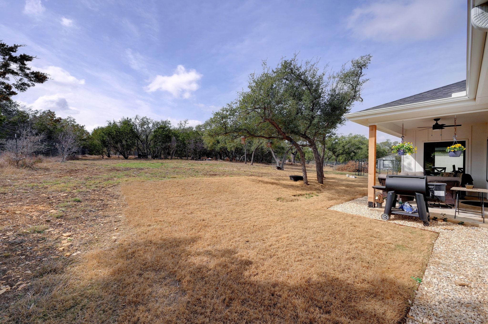 200 Rust Ranch Road Blanco, TX 78606 - Photo 23 of 26 a view of a house with backyard and a sitting area