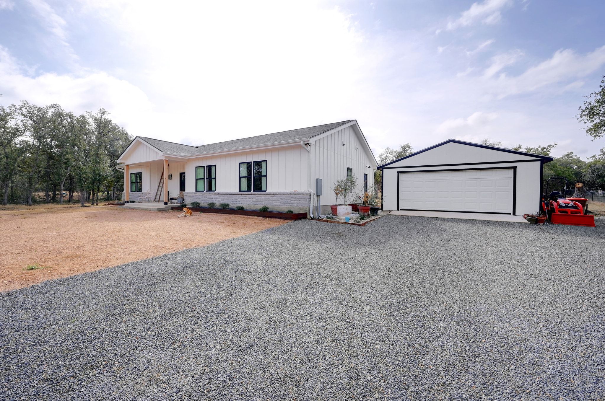 200 Rust Ranch Road Blanco, TX 78606 - Photo 3 of 26 a front view of a house with a yard and garage