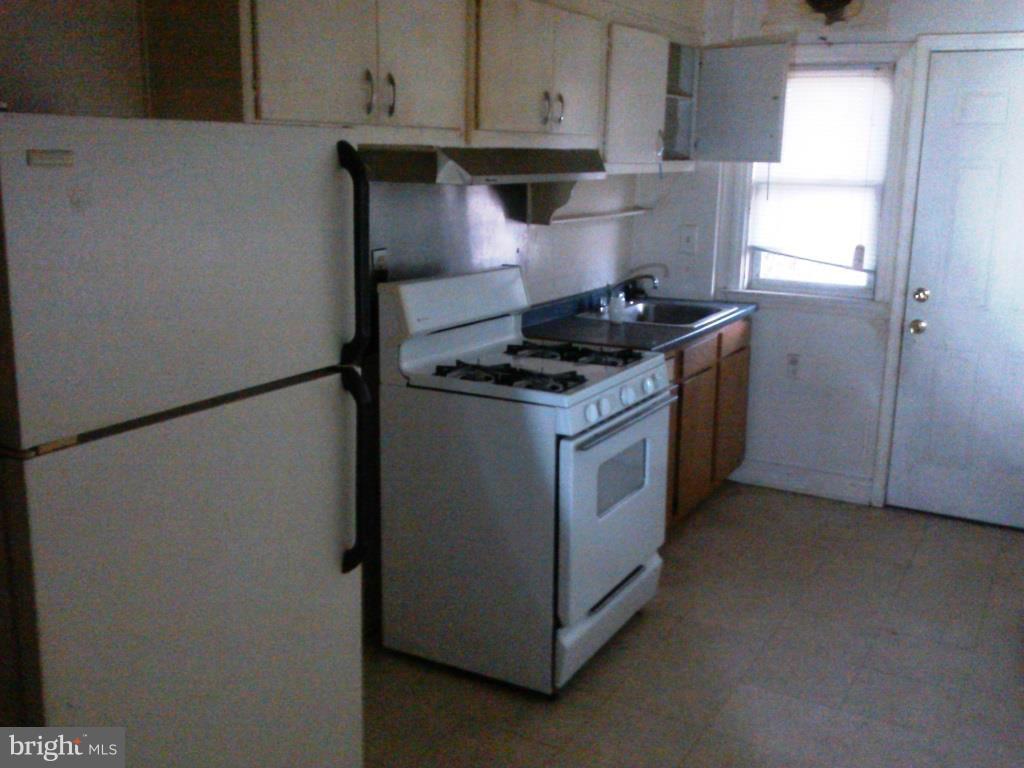 2936 Cornwall Road Dundalk, MD 21222 - Photo 3 of 13 a kitchen with stainless steel appliances granite countertop a stove and a refrigerator