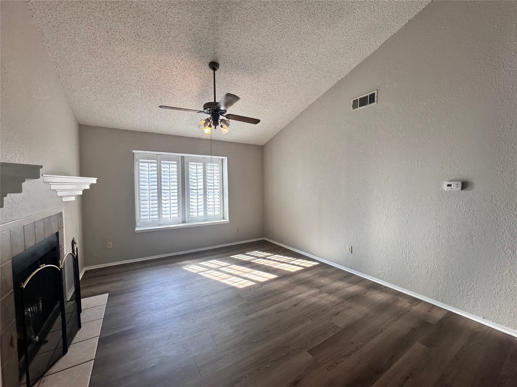 a view of empty room with fireplace and fan