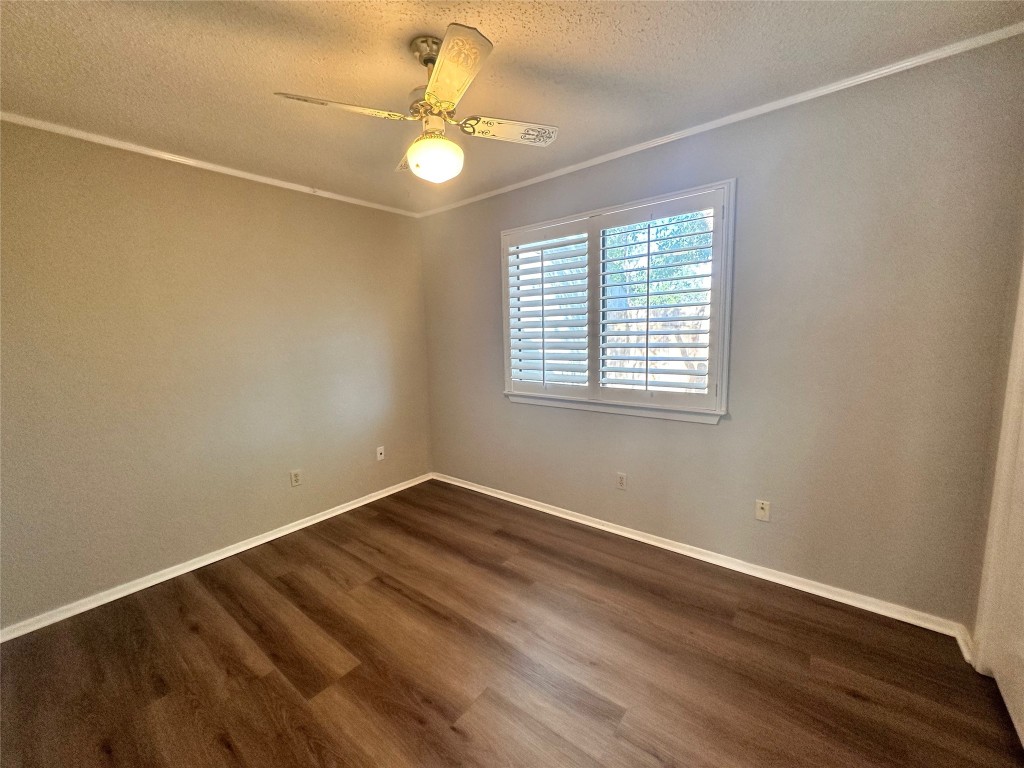 1411 Gracy Farms Lane, Unit 102 Austin, TX 78758 - Photo 7 of 12 a view of an empty room with wooden floor and a window