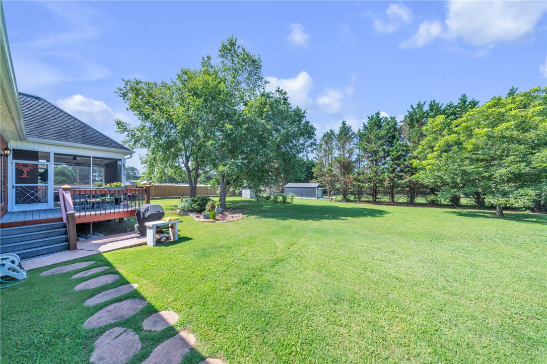 648 Mountain View Road Williamston, SC 29697 - Photo 35 of 42 An inviting screened porch with a spacious backyard, perfect for outdoor living.
