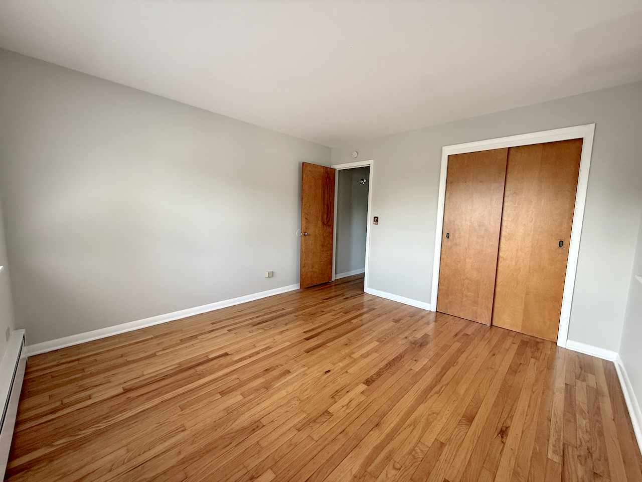 317 South Plum Grove Road, Unit 5 Palatine, IL 60067 - Photo 14 of 14 a view of an empty room with wooden floor and closet