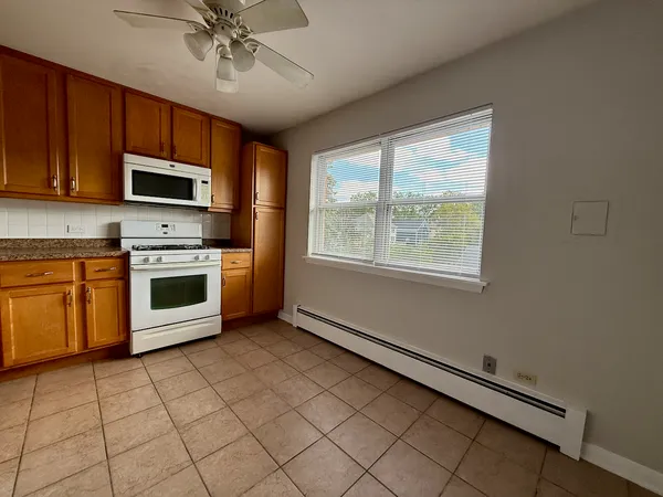 a kitchen with stainless steel appliances a stove sink microwave and cabinets