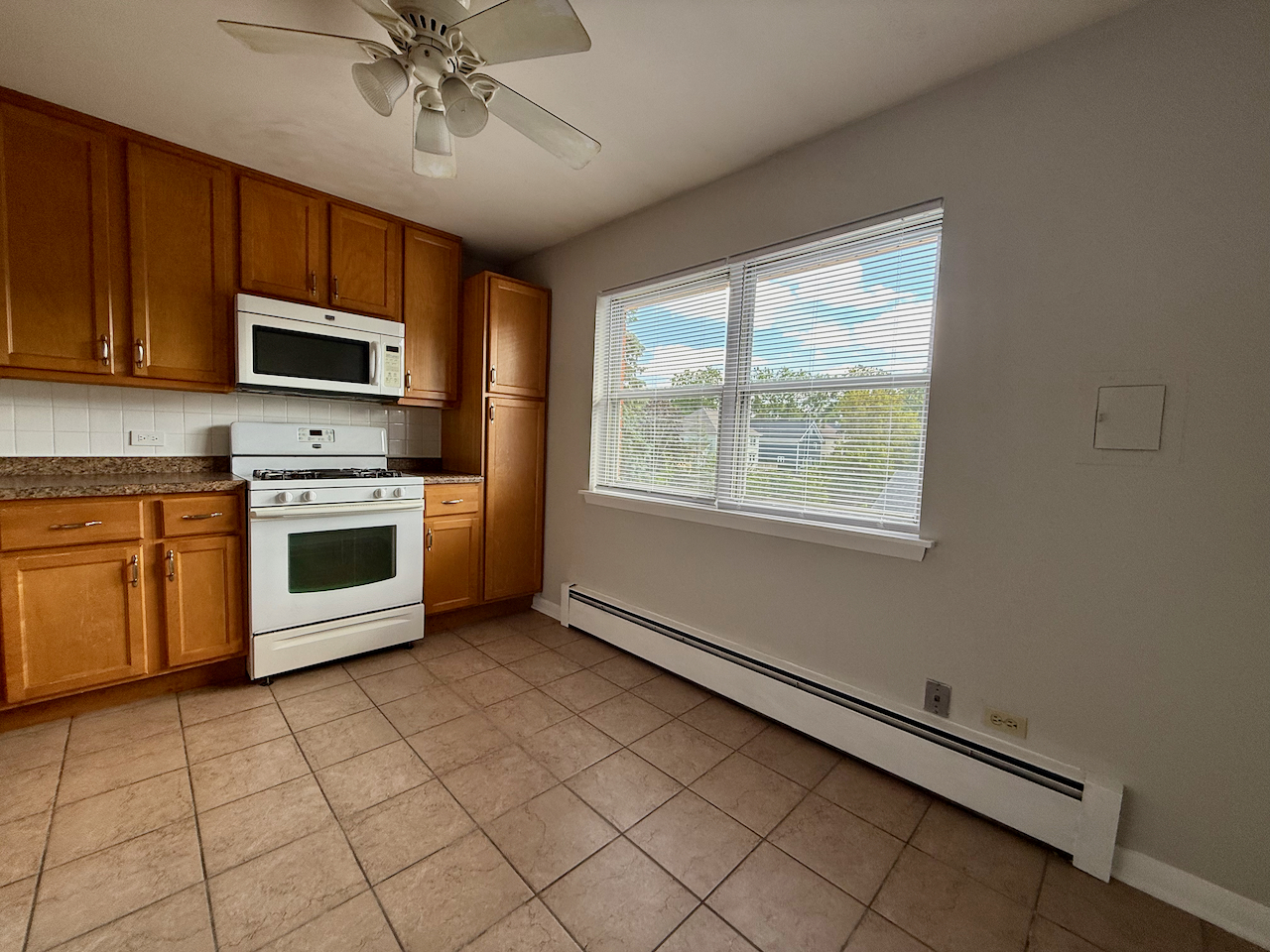 317 South Plum Grove Road, Unit 5 Palatine, IL 60067 - Photo 5 of 14 a kitchen with stainless steel appliances a stove sink microwave and cabinets